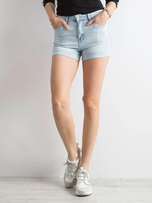 Blue denim shorts with rolled up legs