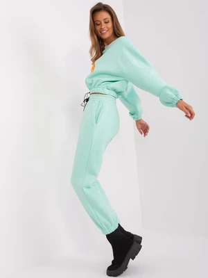 Mint and fluoroorange tracksuit with letter A