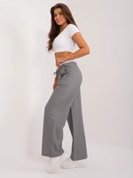 Grey fabric trousers with a white belt