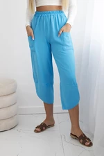 Turquoise trousers with wide legs and pockets