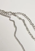 Layered necklace with a silver-colored amulet