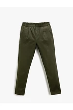 Koton Fabric Carrot Trousers with Button Detail Pocket.