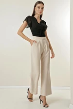 By Saygı A snap fastener at the waist, Pockets and Wide Leg Trousers.