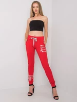 Women's red sweatpants with inscription