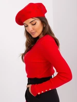 Red women's beret with appliqué