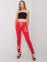 Women's red sweatpants with an inscription