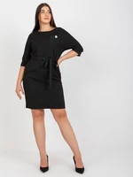 Black pencil dress of larger size with a detail for tying