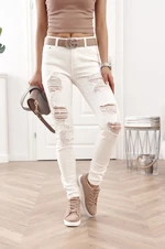 Fitted denim pants with holes in cream color