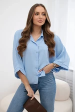 Oversized blouse with blue button fastening