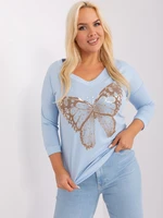 Light blue oversized women's blouse with cuff