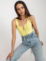 Light yellow women's top with lace-up neckline