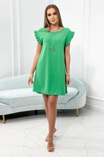 Dress with a decorative pendant of green color