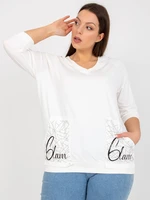 White blouse of larger size with application of rhinestones