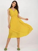 Dark yellow flowing dress with pleats