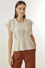 By Saygı The Chiffon Flutter sleeves and a Lycra blouse with a necklace.