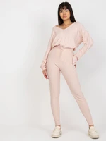 Light pink women's knitted trousers with a tie