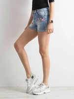 Blue denim shorts with patches