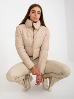 Beige short down jacket made of eco-leather with stitching